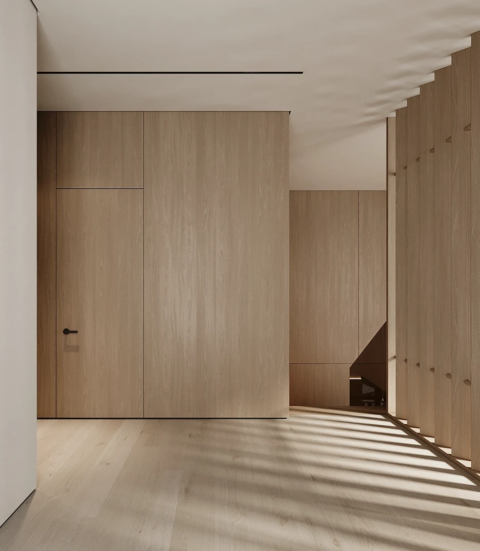 Minimalist interior wood wall panels and door systems in light oak finish