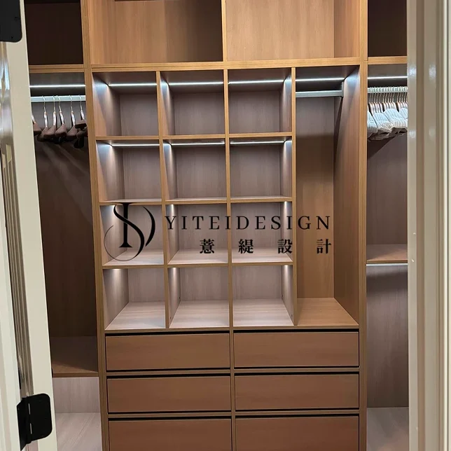 Walk-in closet featuring custom interior woodwork, hanging storage, and organized shelving for a full-home custom look.